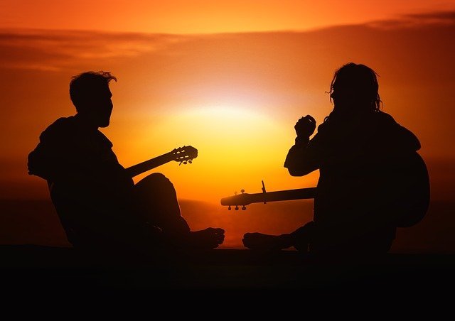 Music Teacher teaching his student in the lap of nature